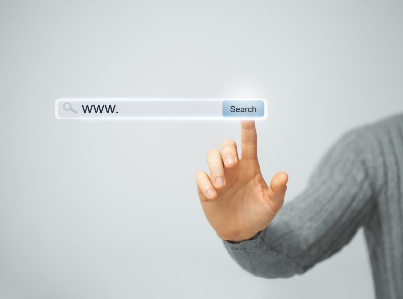 male hand pressing Search button